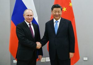 As Biden visits Ukraine, China’s top diplomat goes to Russia